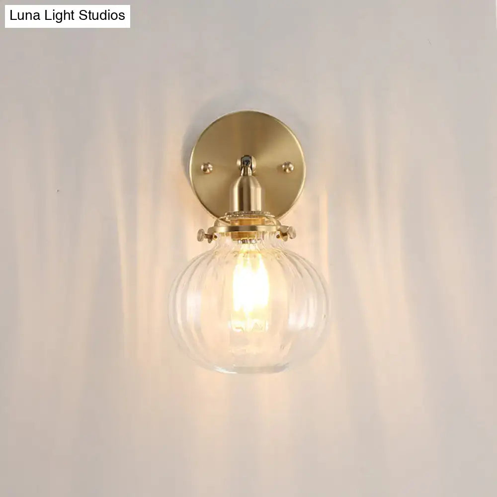 Vintage brass wall light with champagne clear glass shade and ribbed globe for elegant bedroom lighting