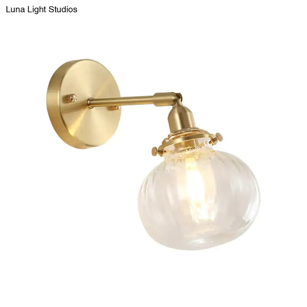 Vintage brass wall light featuring a champagne clear ribbed glass shade ideal for bedroom lighting