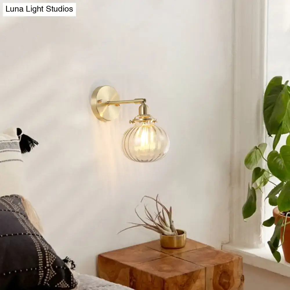 Vintage brass wall light featuring a champagne clear ribbed glass shade for bedroom lighting