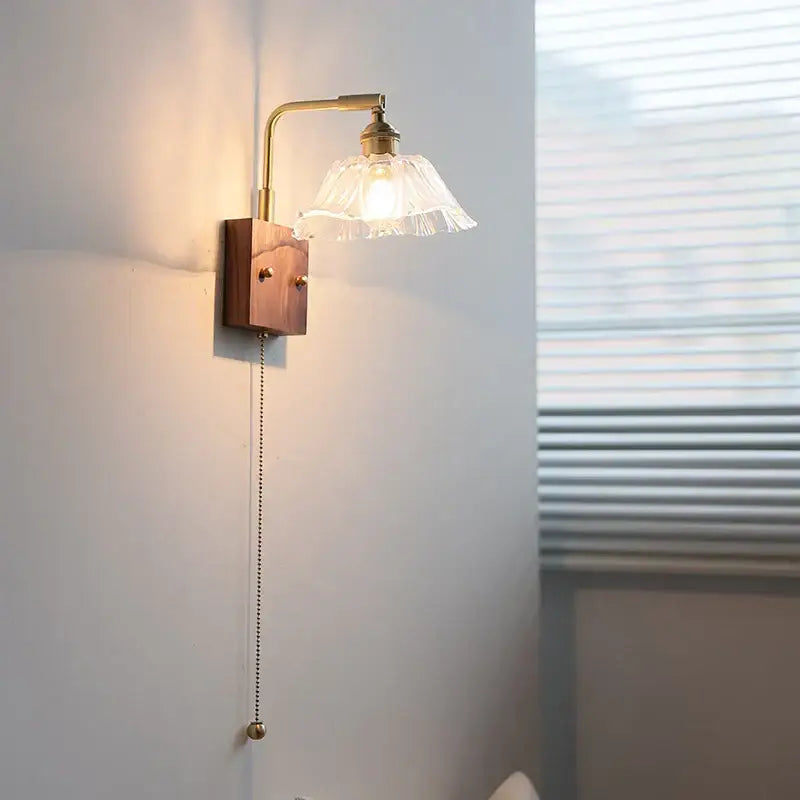 Vintage brass wall light with wooden base and delicate fringed clear glass shade decorbites clear glass bedroom sconce