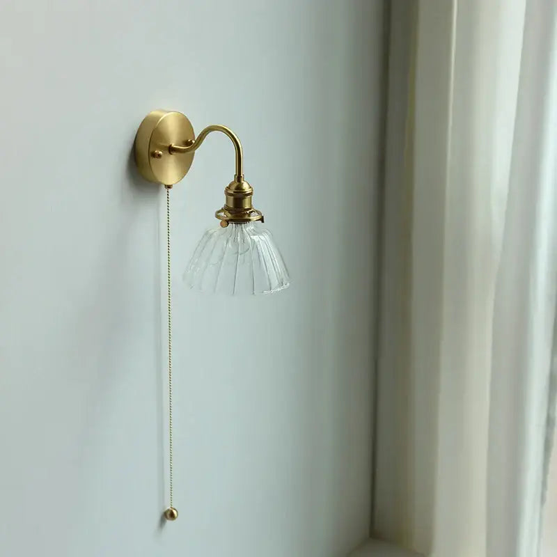 Vintage brass wall sconce with scalloped clear glass shade and ornate pull chain for stairway decorbites clear glass design