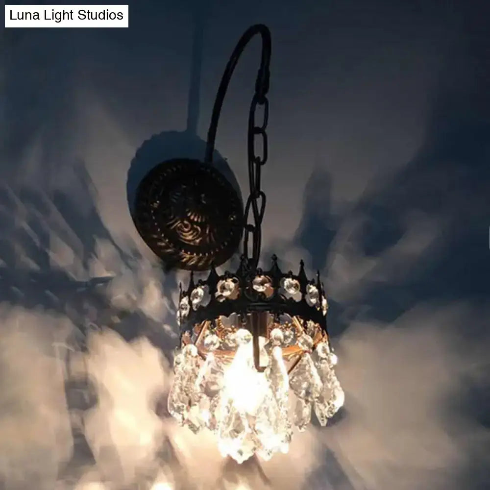 Vintage bronze crystal wall light featuring an antique-style black metal chandelier with clear crystal droplets and decorative crown top