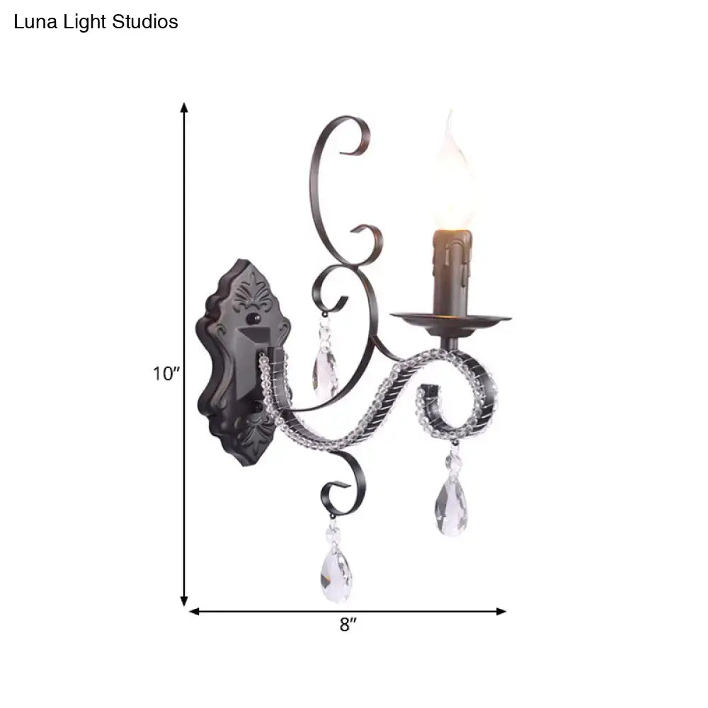 Antique bronze wrought iron wall mounted lamp with crystal teardrop pendants and candle-style bulb for living room