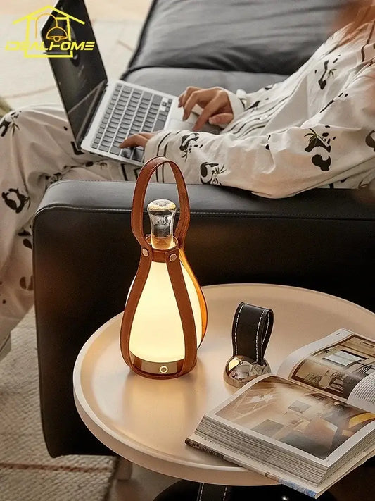 A warm glowing vintage brown leather grapefruit table lamp with a portable handle for bedroom decorbites lighting