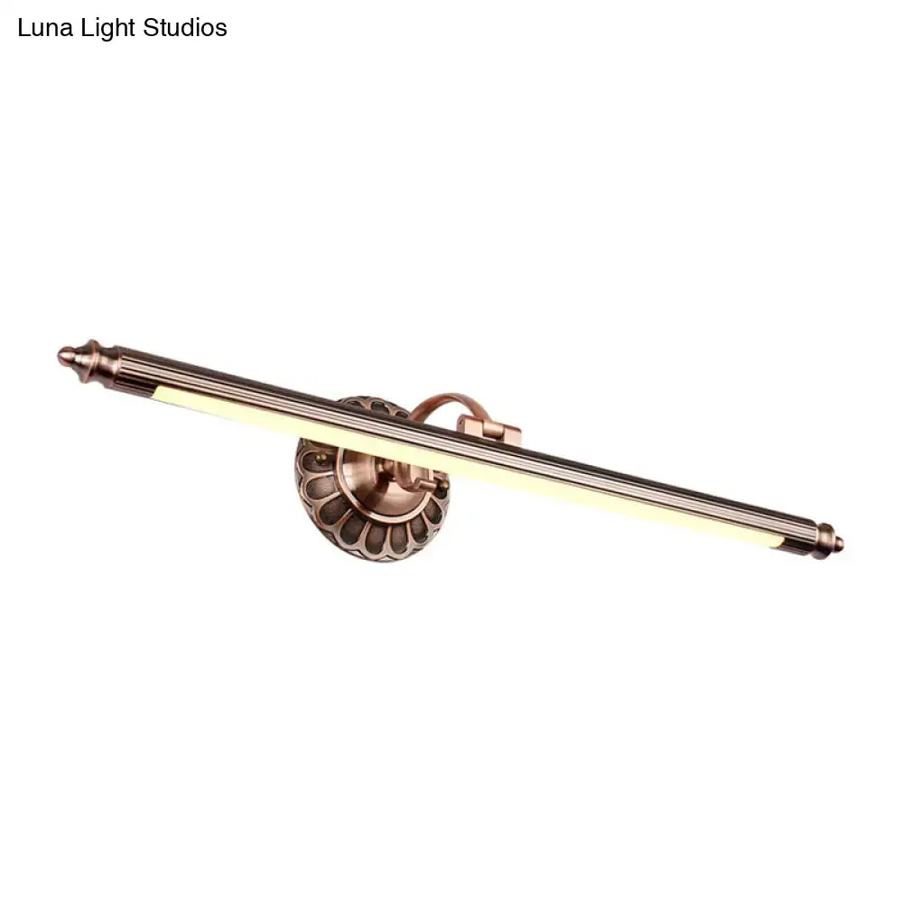 Antique brass-finished metallic sconce wall light with fluted base and cylindrical body for bedroom vanity lighting with max bulb wattage