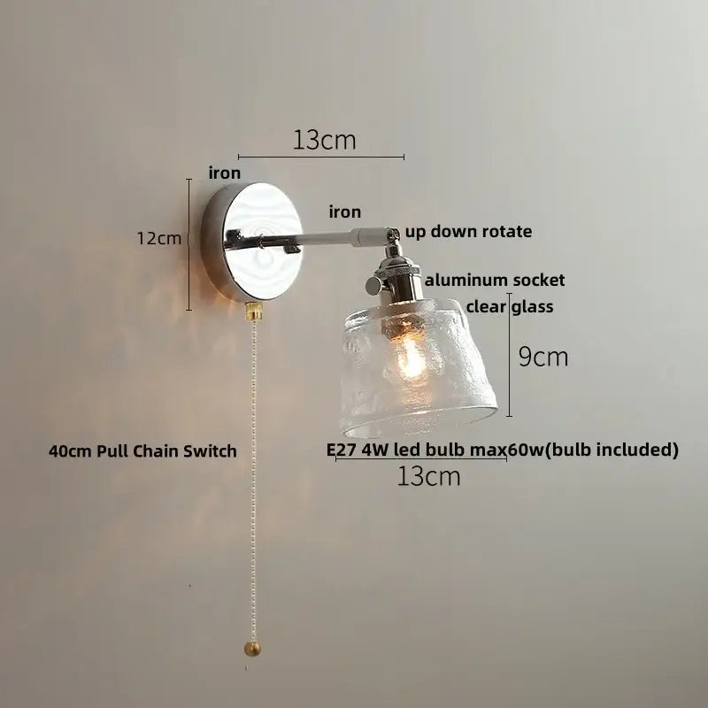 Vintage brushed nickel led wall light with polished iron base, adjustable arm, and textured clear glass shade for bedroom