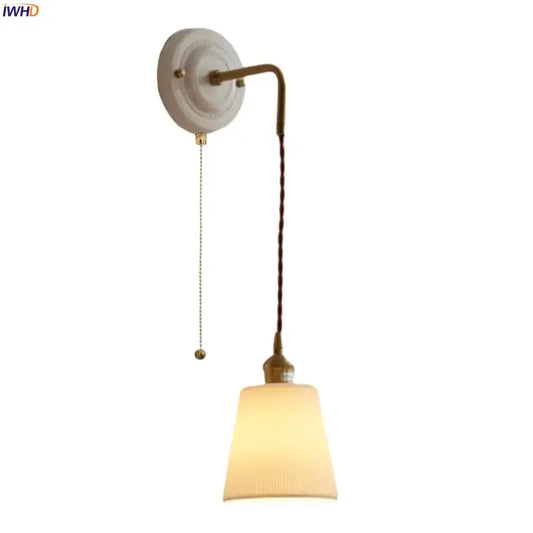 Vintage ceramic and brass wall sconce with adjustable led light, cream base, brass arm, and ribbed off-white shade for bedroom decorbites adjustable led