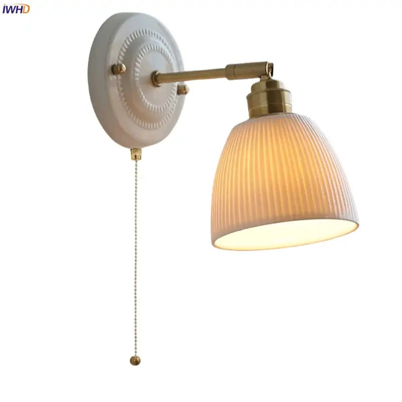 Vintage ceramic and brass wall sconce light with cream backplate and ribbed off-white glass shade pull chain