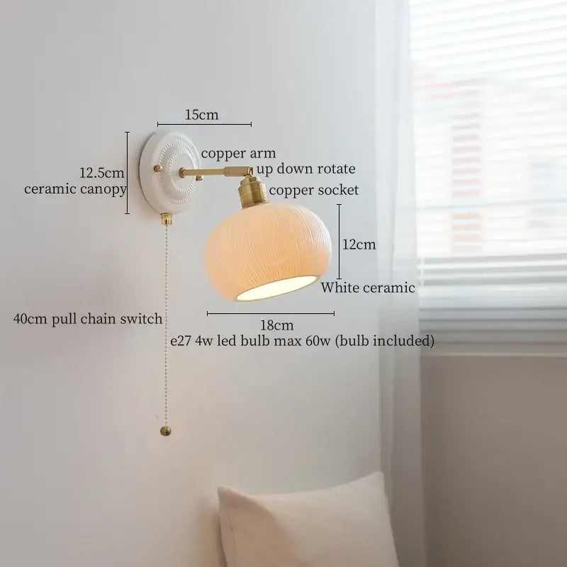 Vintage white ceramic and brass wall sconce light with textured rounded shade and pull chain for bedroom use