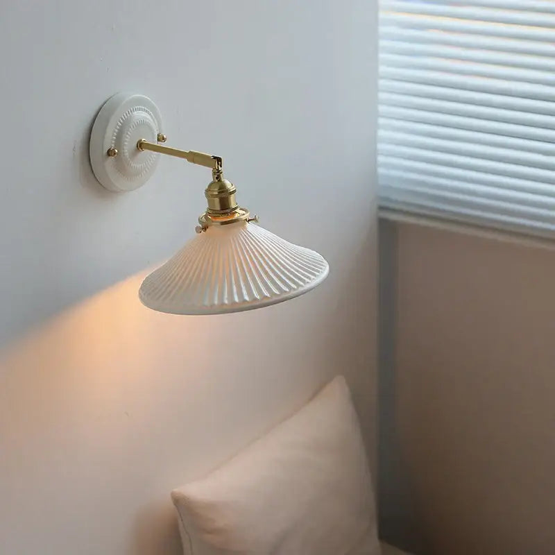 White ceramic led wall lamp with brass-finished arm and fluted shade for vintage bedroom decorbites ceramic led sconce