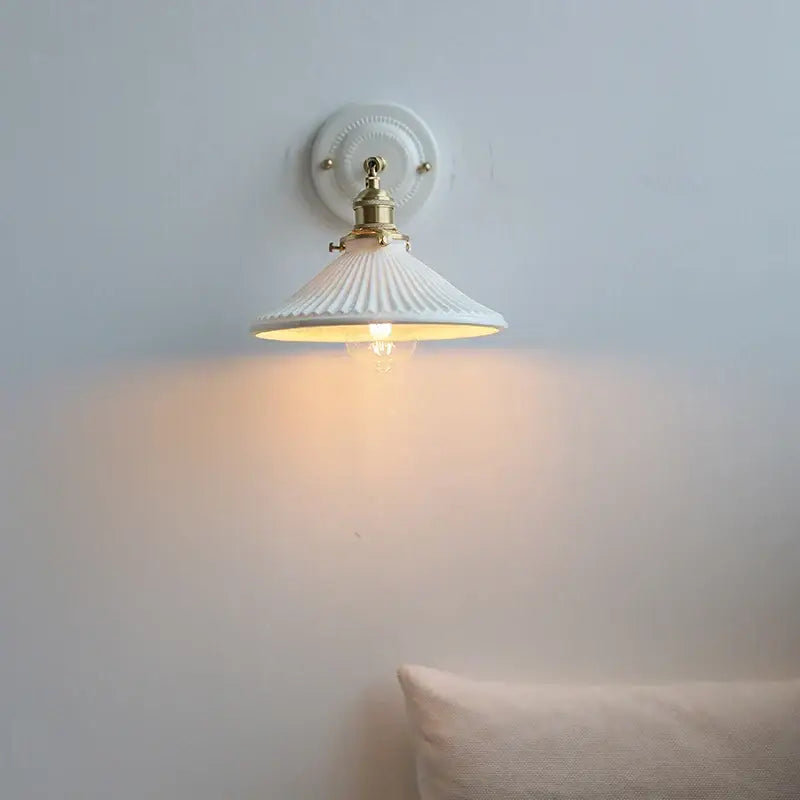 White ceramic led wall lamp with fluted bell-shaped shade and brass accents for vintage bedroom decorbites ceramic led sconce