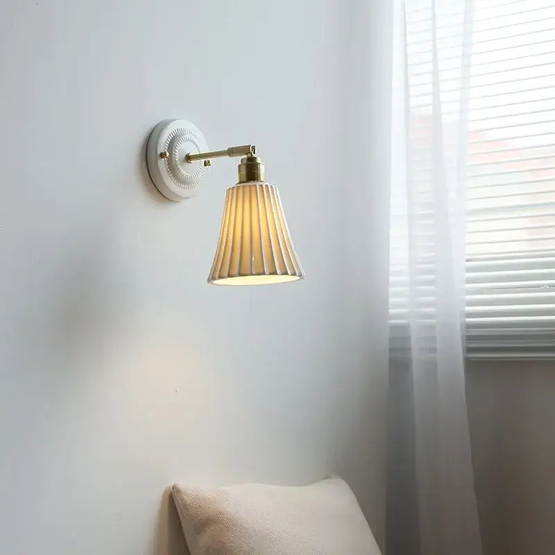 Vintage ceramic wall lamp with brass-finished arm and cream fluted glass shade for warm bedroom lighting decorbites ceramic wall lamp