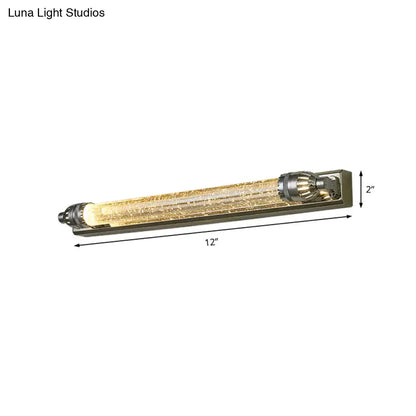 Vintage chrome and crystal led vanity light with textured glass tube and metallic end caps emitting warm glow