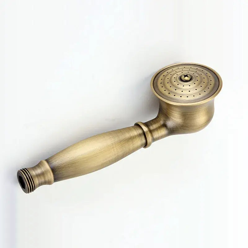Antique brass-finished handheld showerhead with classic elongated handle paired with vintage chrome and white ceramic shower hand holder