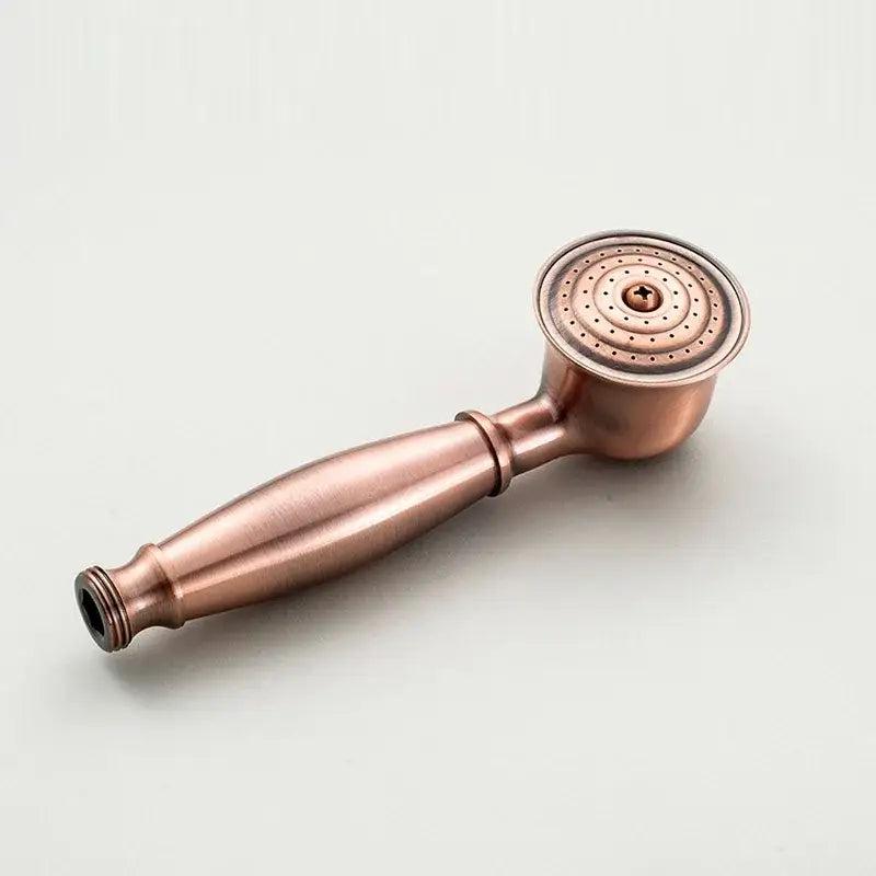 Antique copper-finished handheld showerhead with circular spray face and vintage chrome and white ceramic shower hand holder