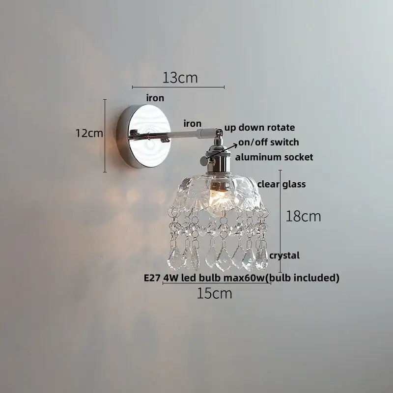 A vintage chrome clear glass wall sconce with a sleek design and dangling crystal droplets for bedroom decorbites clear glass