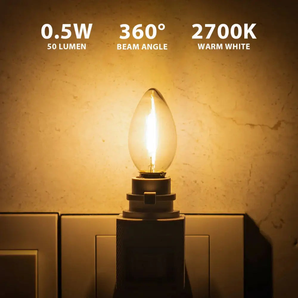 A warm white vintage clear glass dimmable led night light bulb with metal base emitting soft light for bedrooms
