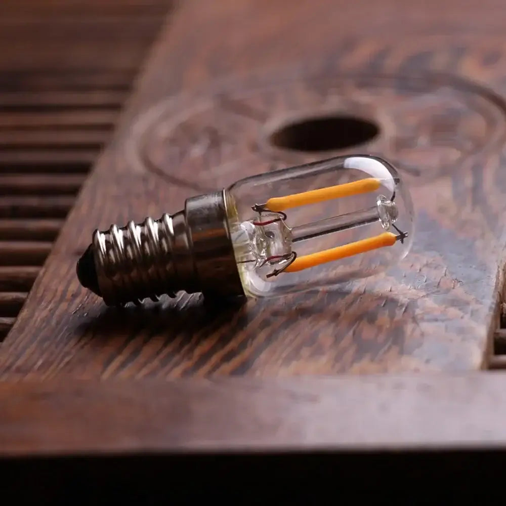 Vintage clear glass led filament night bulb with metallic base and yellow filaments for decorbites dimmable t20 lighting