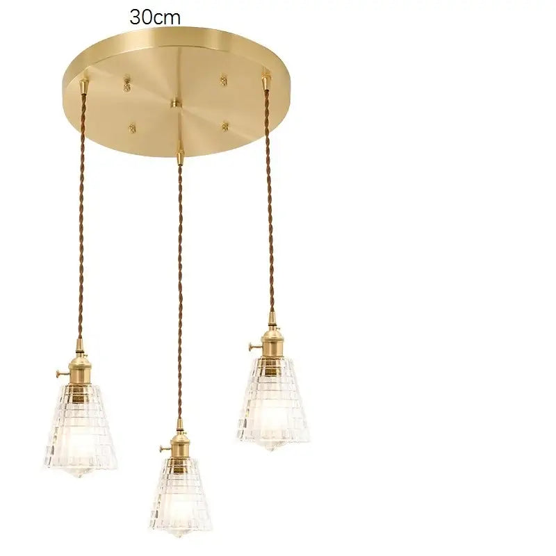 Gold-toned pendant light fixture with three clear and red crystal glass shades and braided copper cords decorbites glass lamp