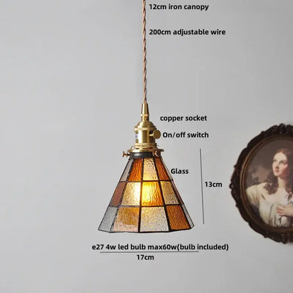 A warm-toned colorful glass tiffany pendant lamp with brass-finished copper socket and adjustable wire suspension
