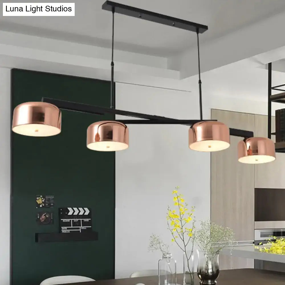 Modern copper-finished bowl linear chandelier with black metal arms and adjustable cord suspended above dining table