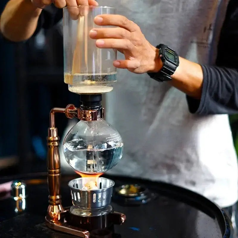 Vintage copper coffee jug siphon maker with glass bulb, brass fittings, and lit flame for decorbites coffee jug use