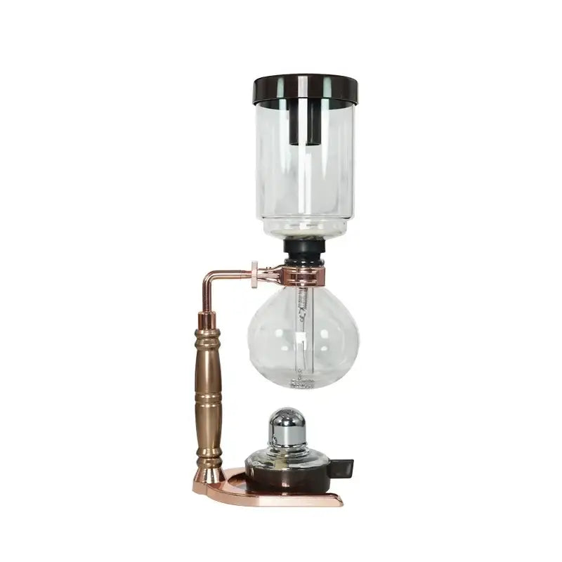 A vintage copper coffee jug siphon maker with a clear glass upper chamber and bulbous lower reservoir decorbites coffee jug