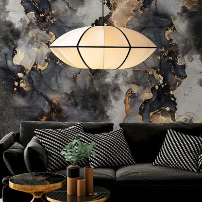 Vintage cream danish fabric pendant lamp with geometric design and black framing hangs above dark sofa decorbites danish fabric
