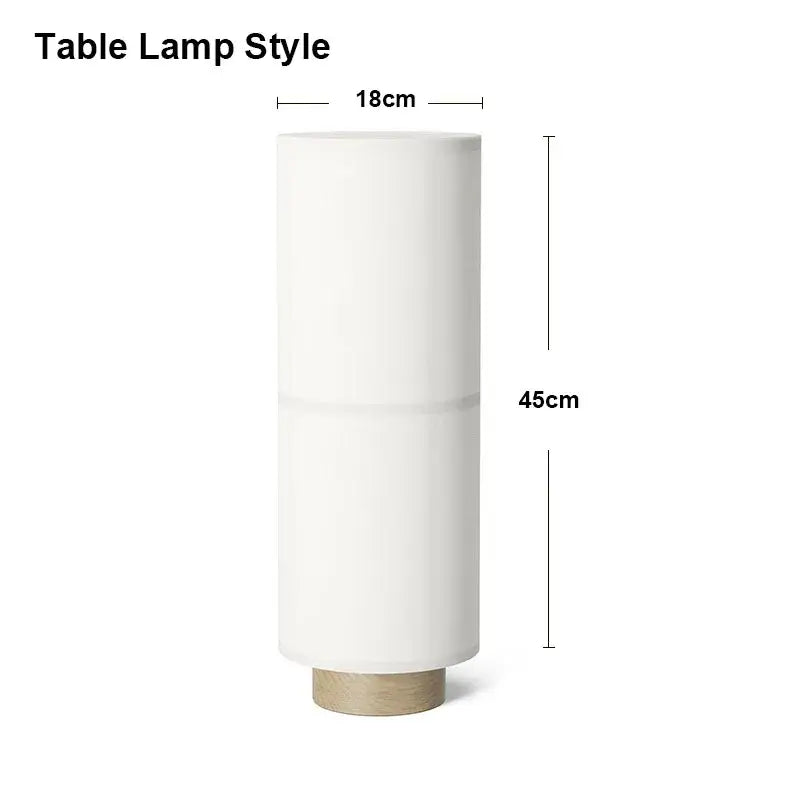 Minimalist white cylindrical table lamp with matte finish and light wood base complements decorbites hashira cluster pendant light