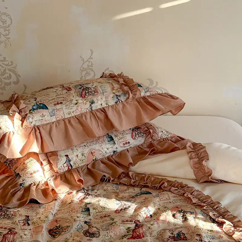 Ruffled vintage-inspired pillowcases in soft peach fabric with delicate french print lace ruffles and historical illustrations