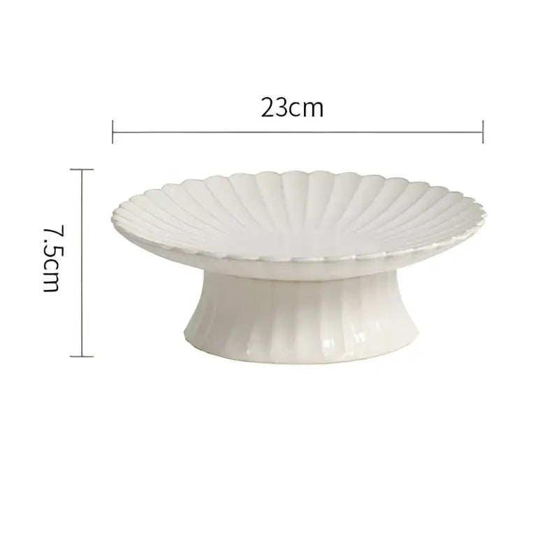 White ceramic cake stand with fluted scalloped edge and pedestal base in vintage cream dining table set