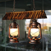 Vintage dark brown metal island light kitchen pendant light with copper lanterns and warm glowing bulbs under wooden canopy