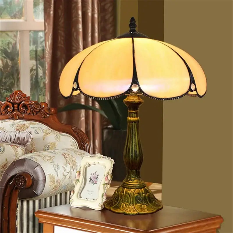 Antique-style vintage dragonfly tiffany stained glass table lamp with amber shade and ornate brass base for bedroom desk use