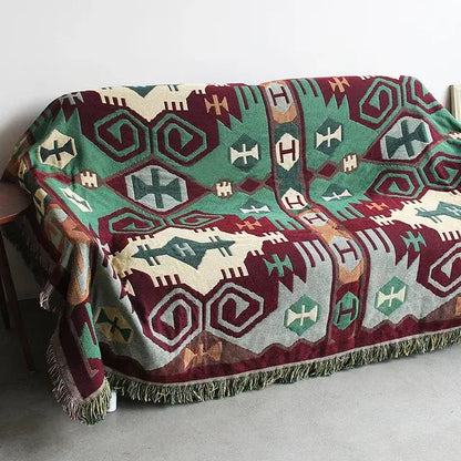 A cozy bohemian cotton plaid sofa blanket in maroon sage green cream tones with fringe trim for living room decorbites bohemian cotton