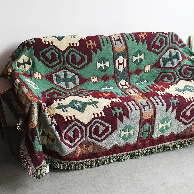 A cozy bohemian cotton plaid sofa blanket in maroon sage green cream tones with fringe trim for living room decorbites bohemian cotton