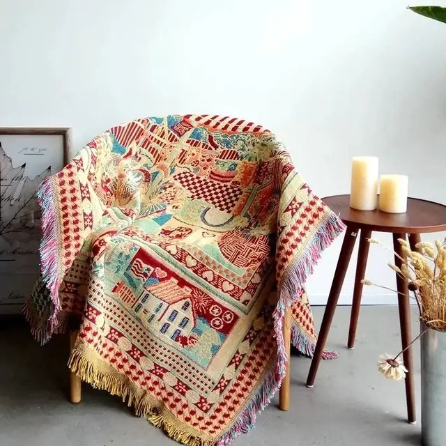 A cozy bohemian cotton plaid sofa blanket with vintage earth tone patchwork in reds blues creams and yellows for living room decorbites