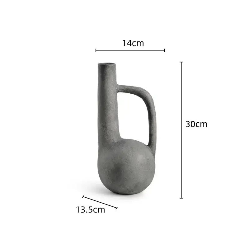 A matte gray ceramic decorbites geometric stoneware vase with a rounded base and integrated handle for living room decor