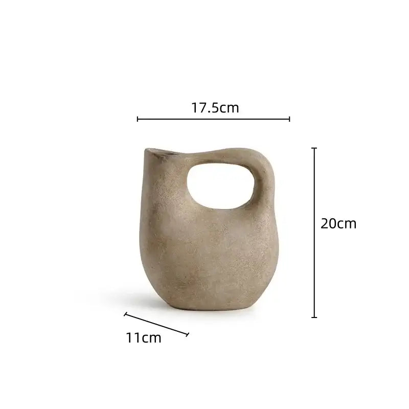 A matte beige ceramic pitcher with rounded body and narrow spout from decorbites geometric stoneware vase set living room decor