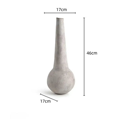 A tall slender concrete geometric stoneware vase with rounded base and tapered neck for vintage living room decorbites decor