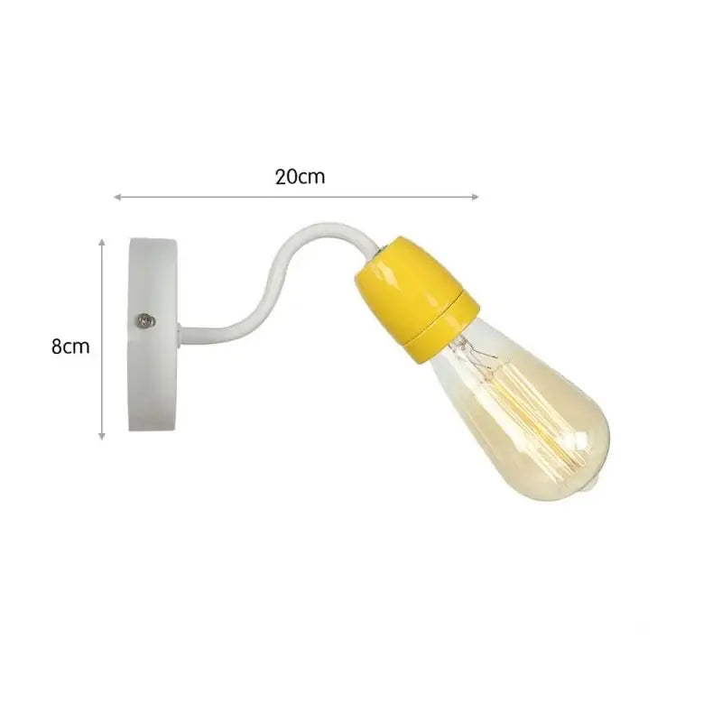 A vintage edison wall lamp with a white curved arm and yellow ceramic cap featuring a colorful ceramic led bulb for bedroom decorbites