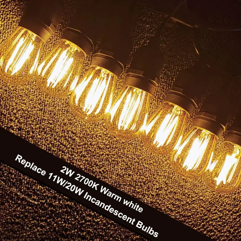 Warm white 2w vintage-style edison filament bulbs with clear glass and black metal caps for decorbites amber plastic patio string light