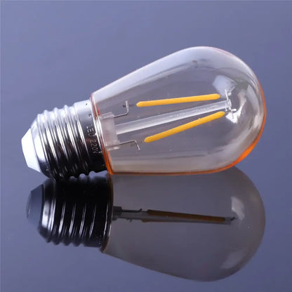 Clear glass edison-style led bulb with yellow filament and black base from vintage decorbites amber plastic bulbs 6-pack