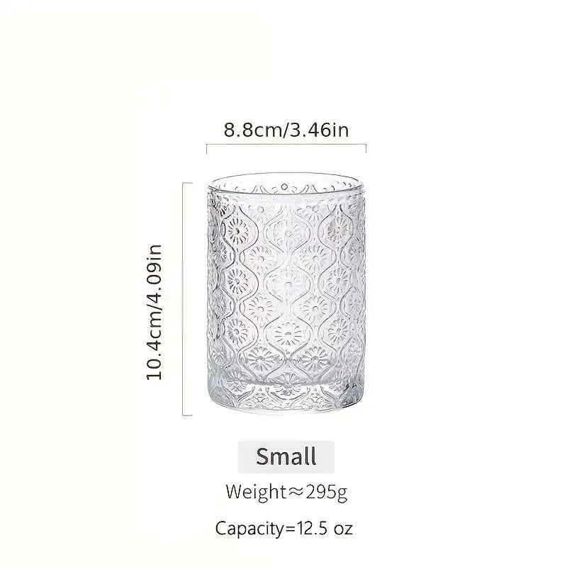 Clear glass vintage glassware tumbler with intricate embossed floral patterns from blue red and gold glassware set