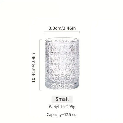 Clear glass vintage glassware tumbler with intricate embossed floral patterns from blue red and gold glassware set
