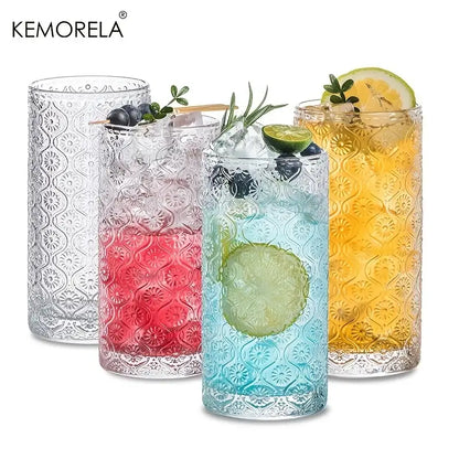 Vintage glassware set featuring clear textured glass tumblers with embossed floral patterns in blue red and gold hues