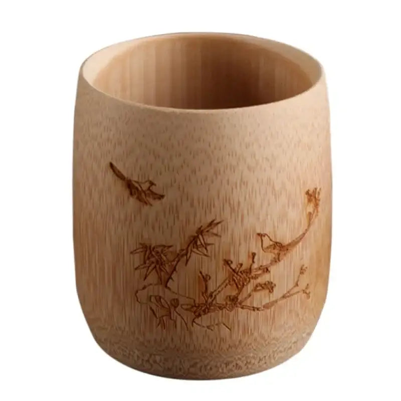 A light brown vintage engraved bamboo drinking cup with birds and branches design for dining room tea decorbites bamboo set