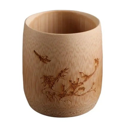 A light brown vintage engraved bamboo drinking cup with birds and branches design for dining room tea decorbites bamboo set