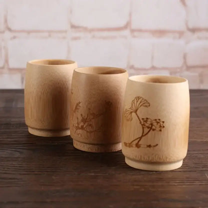 Three light beige vintage engraved bamboo drinking cup holders with intricate botanical designs from decorbites bamboo drinking set