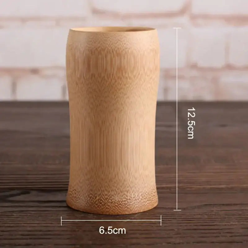 A light brown bamboo drinking cup with a natural textured surface in the vintage engraved bamboo drinking cup set by decorbites