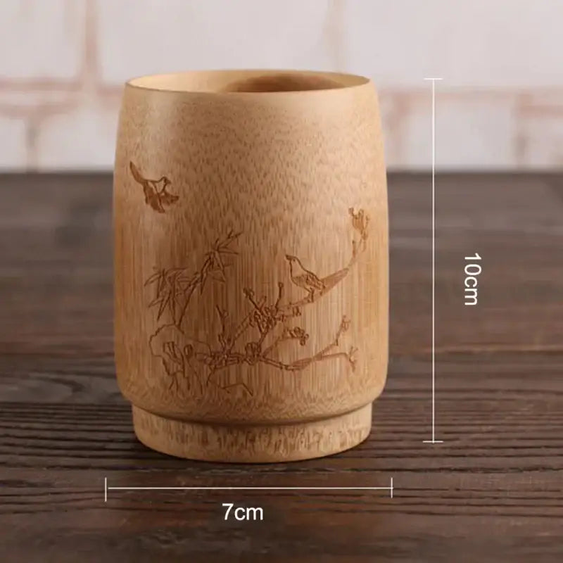 A light brown bamboo drinking cup from decorbites with vintage engraved birds and branches in a drinking cup set